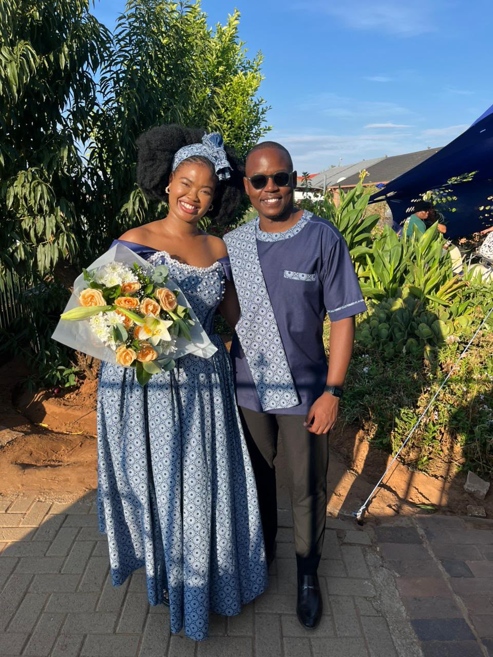 Chukwuma and Ellen smiling together in matching traditional attire